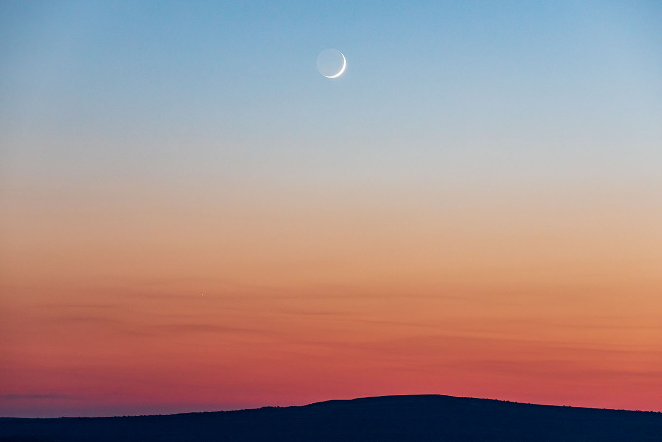 sunset colors with crescent moon