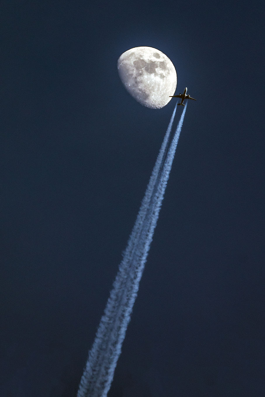 jet flies by moon